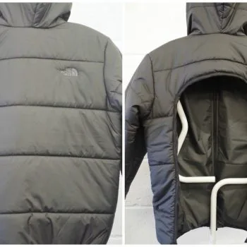 Black padded coat shown with rear zip fastening opening in horsehoe shape